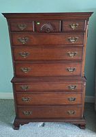 Front view of mahogany dresser showing nine drawers and hardware