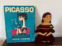Poster and wooden figure side by side