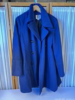 Full front view of navy Anne Klein peacoat on hanger