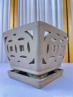 overall view of square terracotta planter on saucer