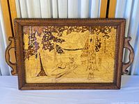 Full view of tray showing frame, handles, glass front and pyrography scene