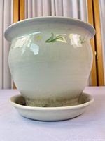 Front view of ceramic planter with saucer