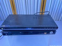 Top view of both players stacked, power cords visible