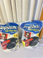 Front view of both sealed Polaroid PopShots cameras in original pouches