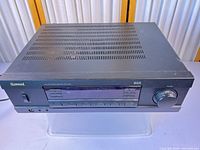 Front angled view of Sherwood RX-4103 receiver showing full unit, display, buttons and volume knob