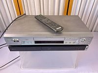 Front view of both media players stacked with remote on top