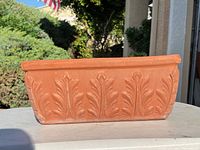 Front view of terracotta planter showing leaf relief detail