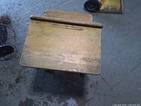 Top view of child desk showing worn wood writing surface