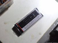 Front of sealed RCA Blu-ray remote in packaging