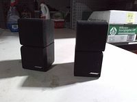 Front view of both Bose double cube speakers showing stacked cube design and Bose logos