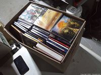 Open box showing rows of CDs in jewel cases