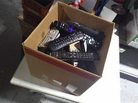 Top view of open box showing multiple remote controls stacked inside