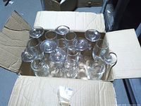 Box containing 17 clear glass champagne flutes