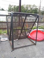 Front/side view of one metal log rack showing frame and mesh