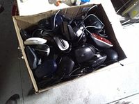 Top view of cardboard box filled with assorted wired computer mice