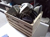 Top view of wood crate filled with assorted computer speakers
