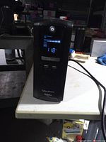 Front view showing LCD, power button, branding and model