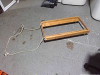 Top view of wooden dolly showing frame and rope