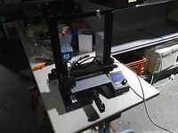 Full view of Creality Ender 3 printer on table showing frame, bed, control box