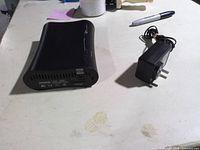 External hard drive and adapter on table