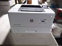 Front view of HP LaserJet Pro M402n printer showing HP logo and model label