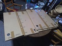 Two Ikea AULI mirror panel boxes on table