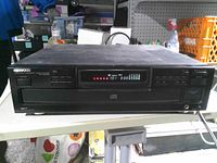 Front view showing Kenwood branding, LED display, control buttons and disc drawer