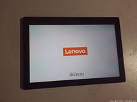 Front of tablet powered on showing Lenovo Android boot screen