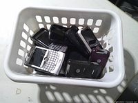 Top view of basket showing assortment of old phones