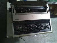 Front view showing keyboard, carriage and brand label