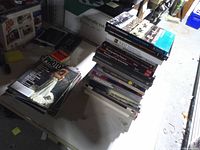 Oblique view of books and magazines on table