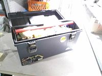 Closed Plano toolbox on table, showing latches and exterior condition