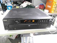 Front view of RCA DRC300N DVD player showing display and buttons
