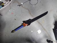 Full view of sword with sheath underneath