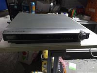 Front angled view showing Samsung branding, disc tray and control knob