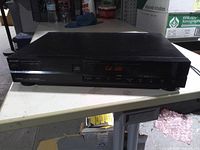 Front view showing Sharp branding, control panel and lit display
