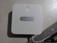 Top view of Sonos Bridge with LED and connected power cable
