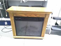 Front view of oak-finish mantel electric fireplace heater