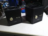 Front view of both TDK A33 speakers showing volume knobs and controls