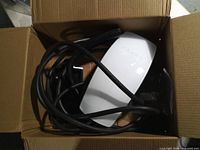 Tesla wall connector and cable inside box