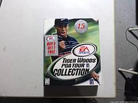 Front of sealed game box showing title, EA Sports logo, 15 courses badge, ESRB E