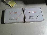 Front view of two sealed Trackmate Dash 11 LTE GPS tracker boxes
