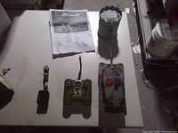 Full set laid out on table showing tank, turret, controller, charger and manual