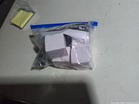 Ziplock bag containing four white USB-C power adapters