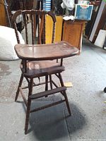 Front view of entire wooden highchair