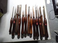 Group of woodturning chisels laid out showing handles