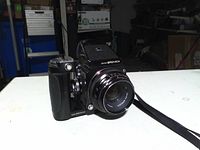 Front three-quarter view of Bronica ETR body with lens, grip and strap