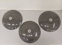 Top view of three glass shades showing concentric ring pattern