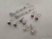 All five pairs of 925 silver earrings laid out