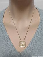 Pendant on mannequin showing size and drop